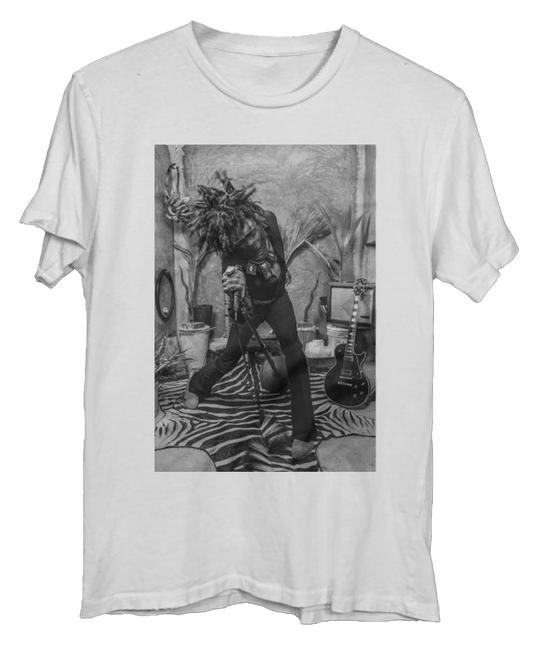 White t-shirt with a black-and-white image of Lenny Kravitz mid-performance, leaning into a mic stand on a zebra rug.