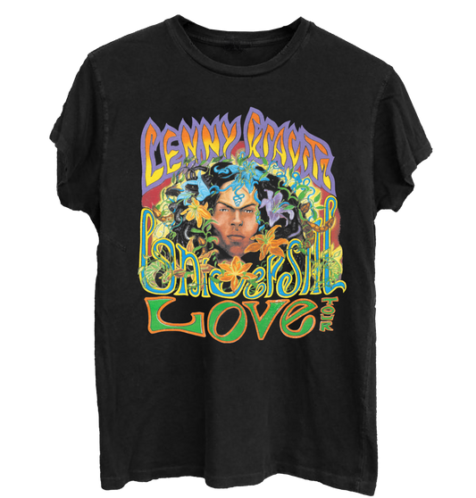 Black t-shirt with colorful graphic design featuring a face and Lenny Kravitz Universal Love Tour text on a white background
